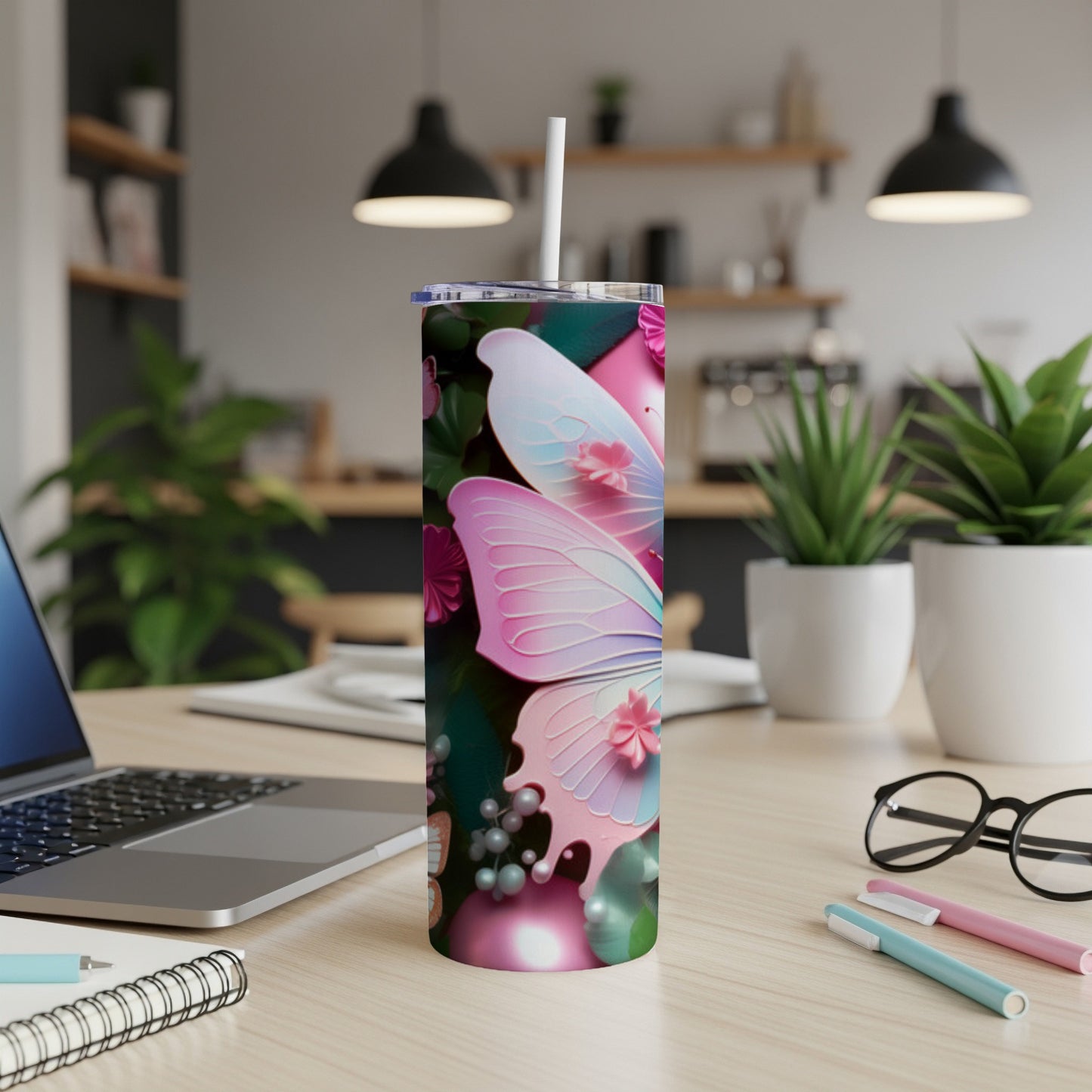 Pink and blue butterfly design on a white tumbler with a straw.
