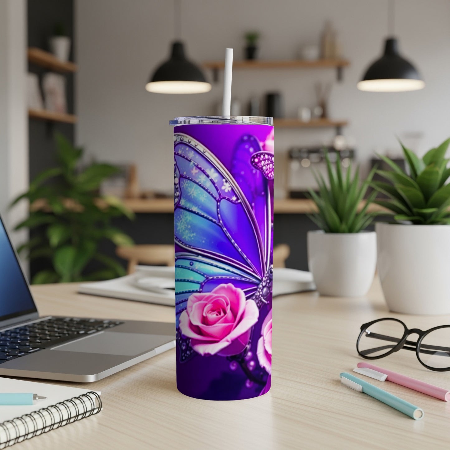 Purple tumbler with butterfly wing and rose design and white straw.