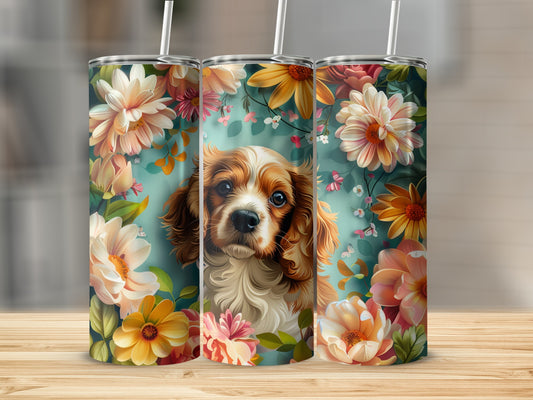 Cavalier King Charles Spaniel among floral illustrations on a tumbler.