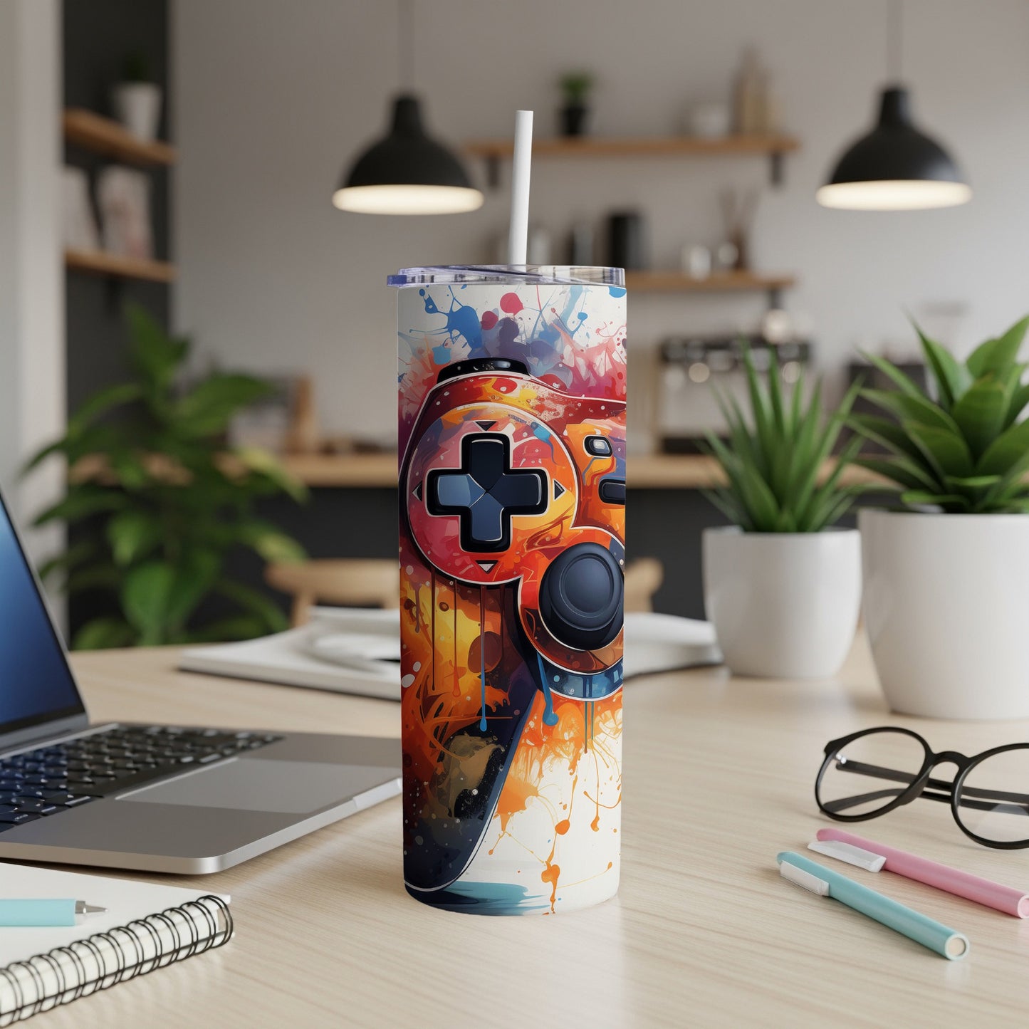 Colorful video game controller design on a white insulated tumbler.