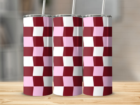 Three tumblers with a pink and burgundy checkerboard pattern on a wooden surface.