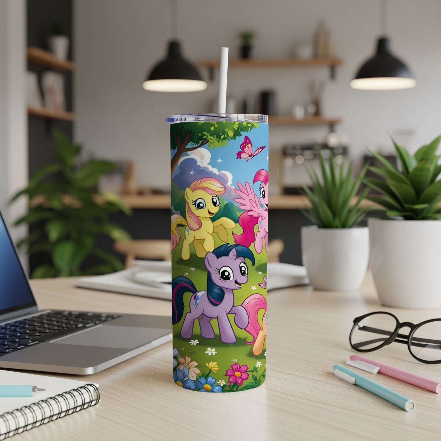My Little Pony characters on a skinny tumbler with a straw in a home office setting.