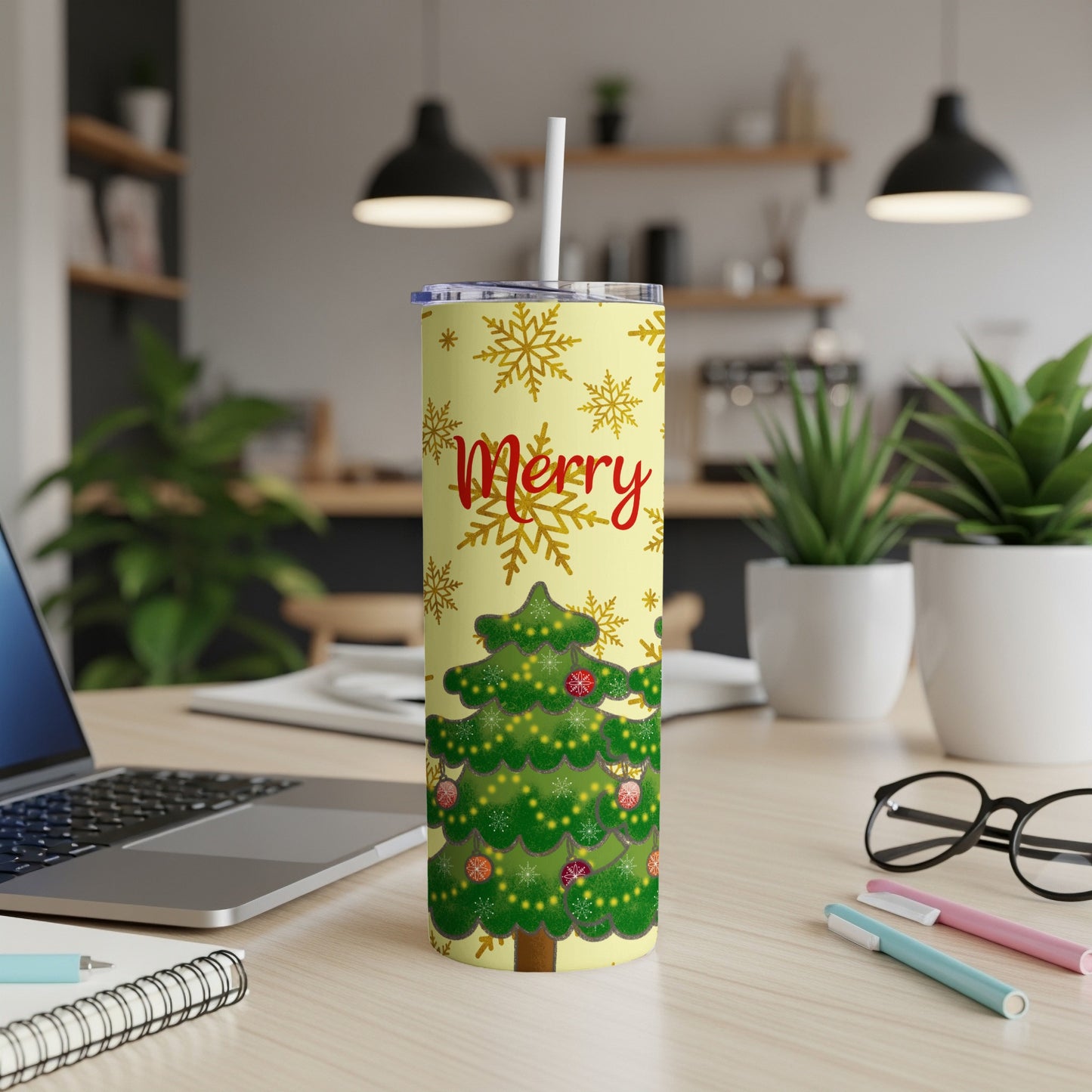 Christmas tumbler with snowflakes and decorated tree design.