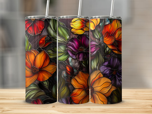 Three tumblers with a stained glass floral design on a wooden surface.