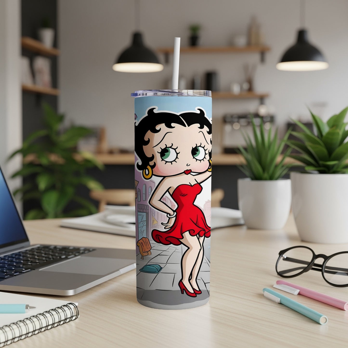 Betty Boop in a red dress standing on a city sidewalk with a laptop nearby.