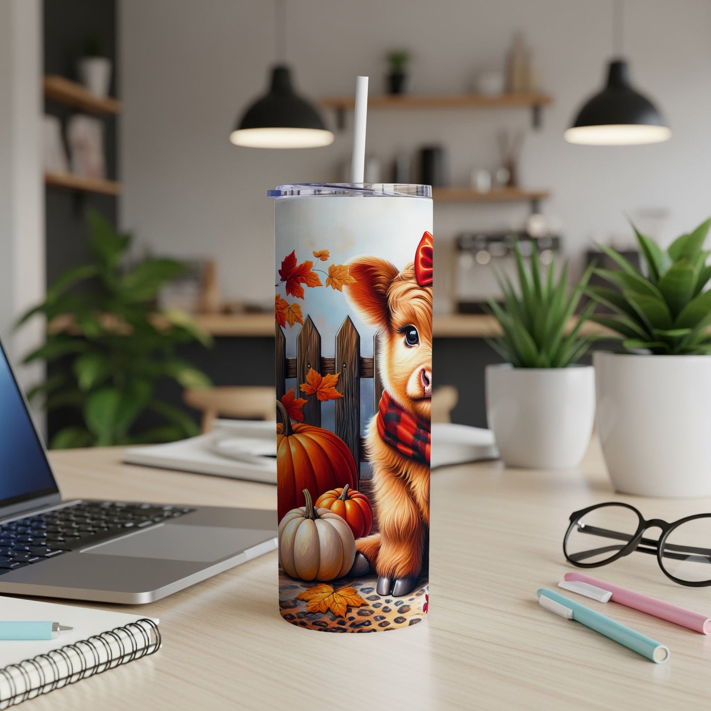 Cow with pumpkin and autumn leaves on a patterned tumbler.