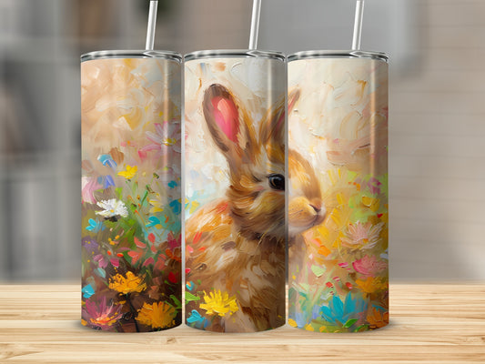 Bunny among colorful flowers on a white tumbler with straw.