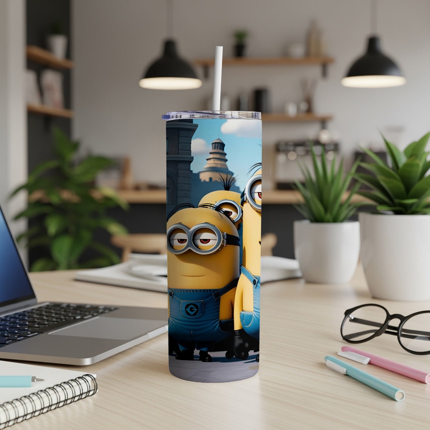 Minions from Despicable Me on a blue tumbler with a straw.