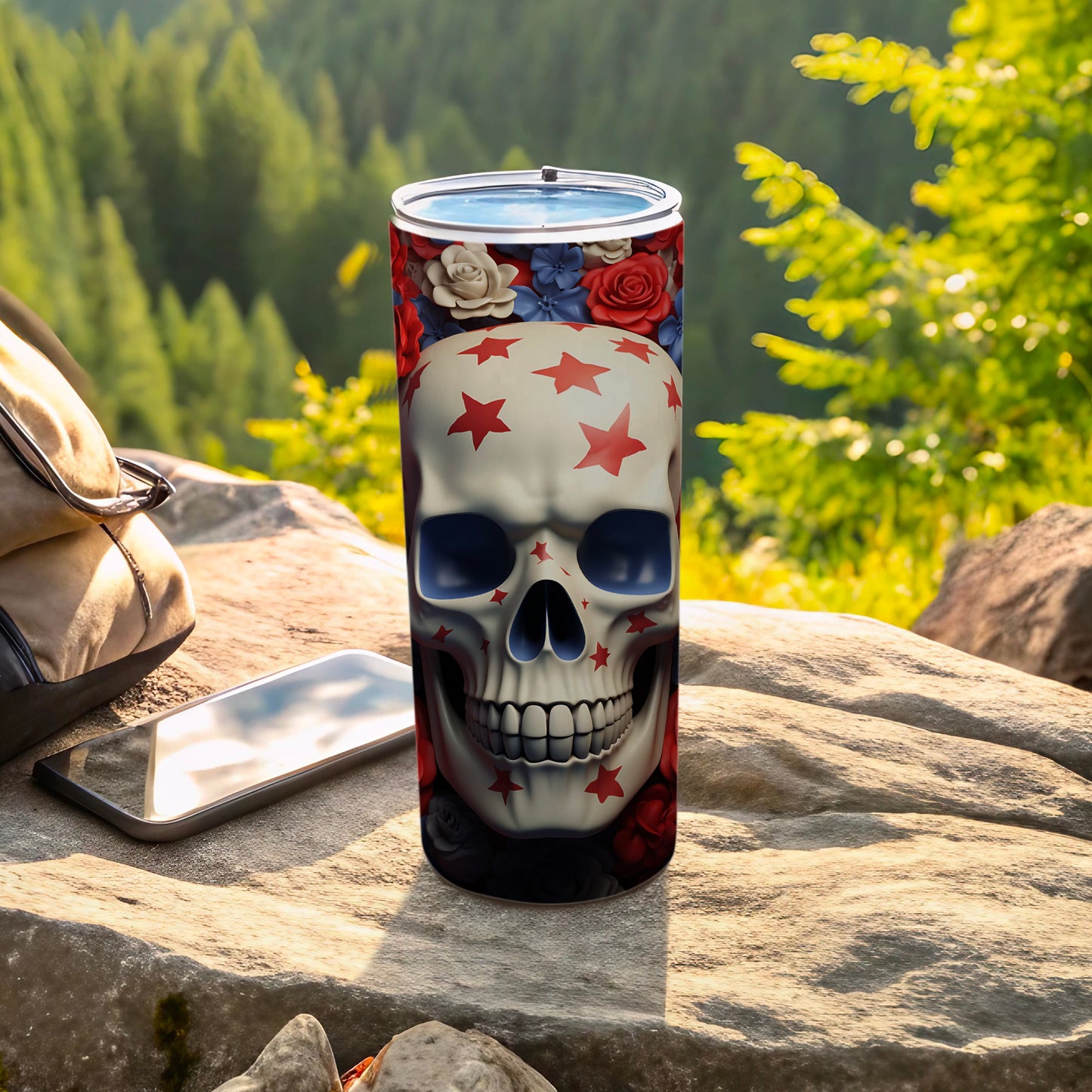 Skull tumbler with red stars and floral accents on an outdoor rocky surface.