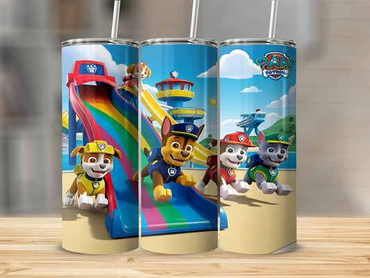 Paw Patrol characters slide down a rainbow on a beach under a blue sky.