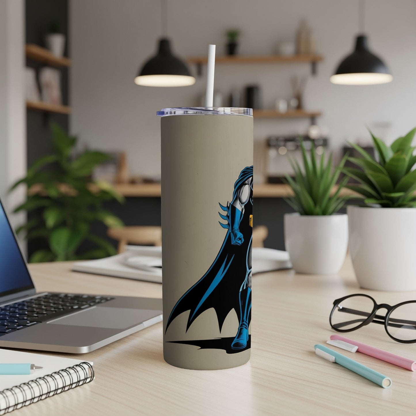 Batman tumbler with black and blue costume against a beige background.