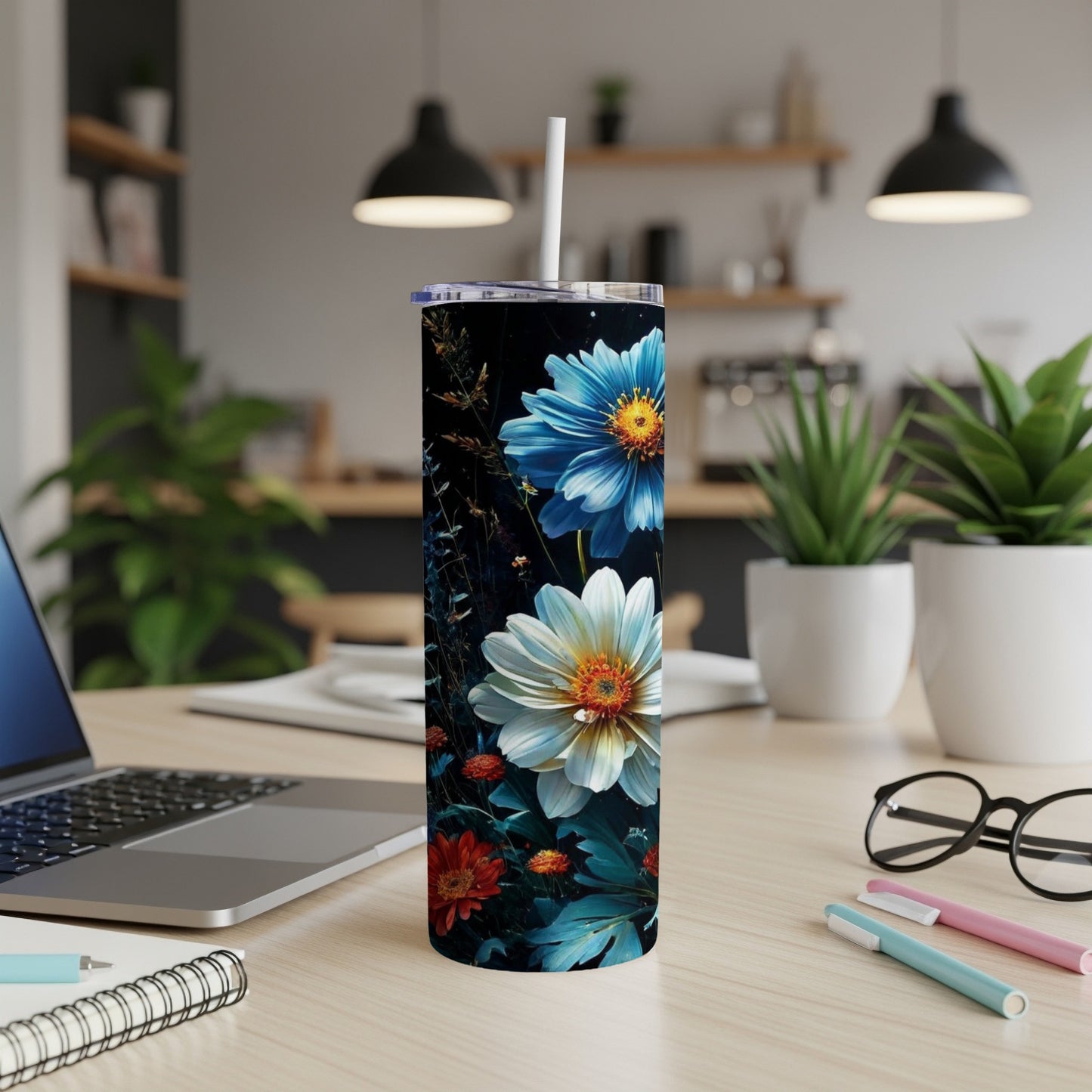 Tall, dark tumbler with a vibrant floral design, featuring blue and white daisies.