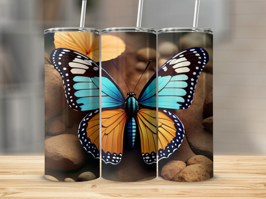 Butterfly artwork on three tumblers with straw.