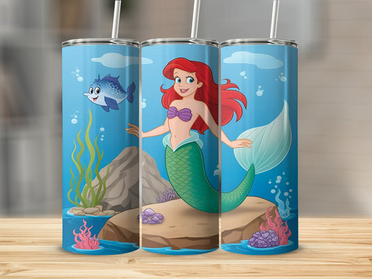 Ariel the mermaid swims in the ocean with a fish and seaweed.