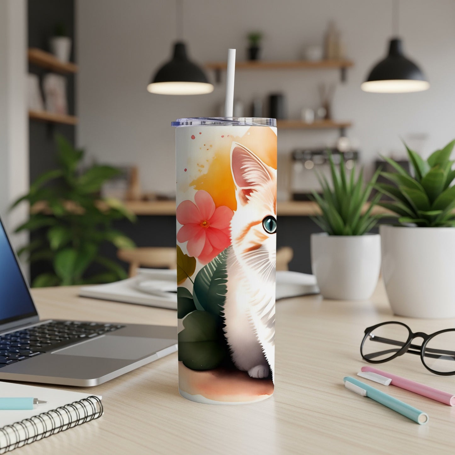 Orange and white tabby cat peeking from behind foliage on a floral patterned tumbler.