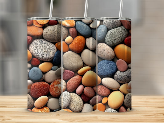 Three tumblers decorated with a mosaic of colorful, smooth pebbles.