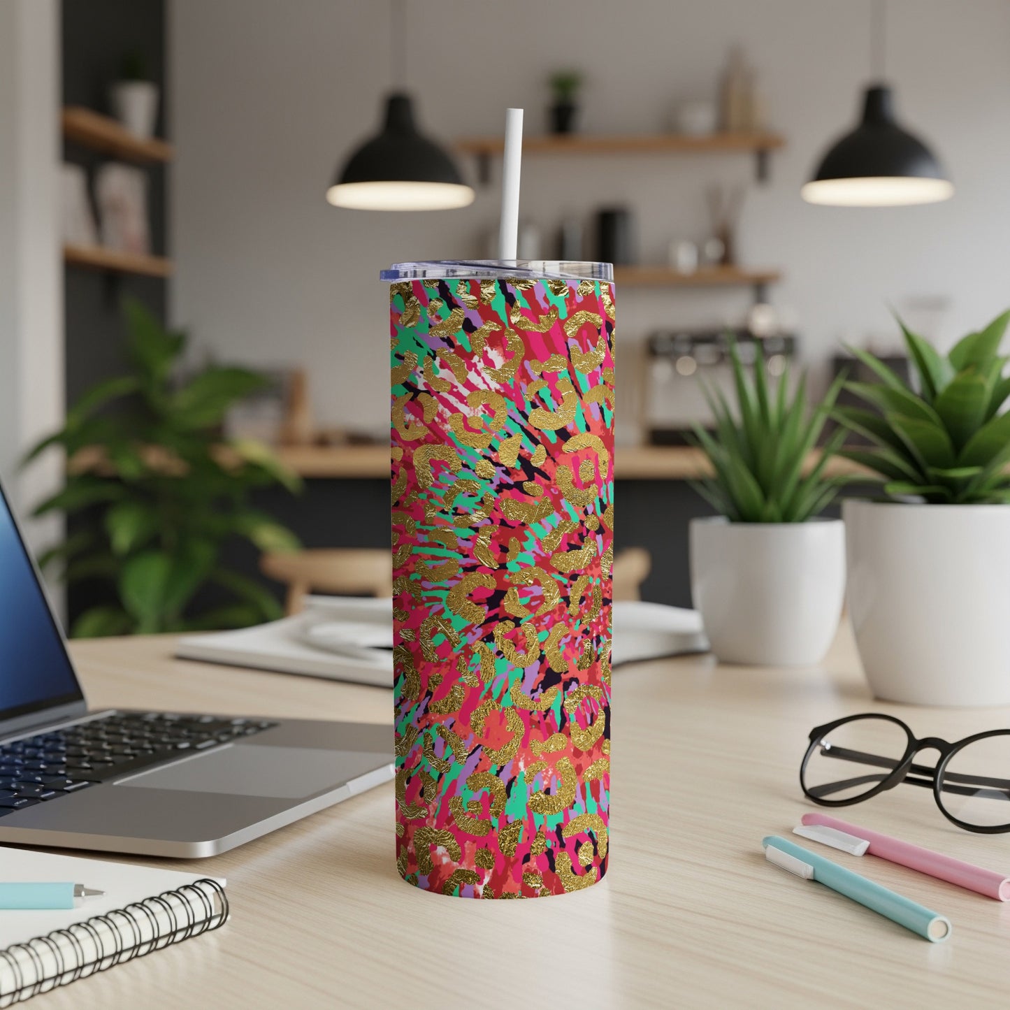 Tall tumbler with colorful abstract pattern and gold accents.