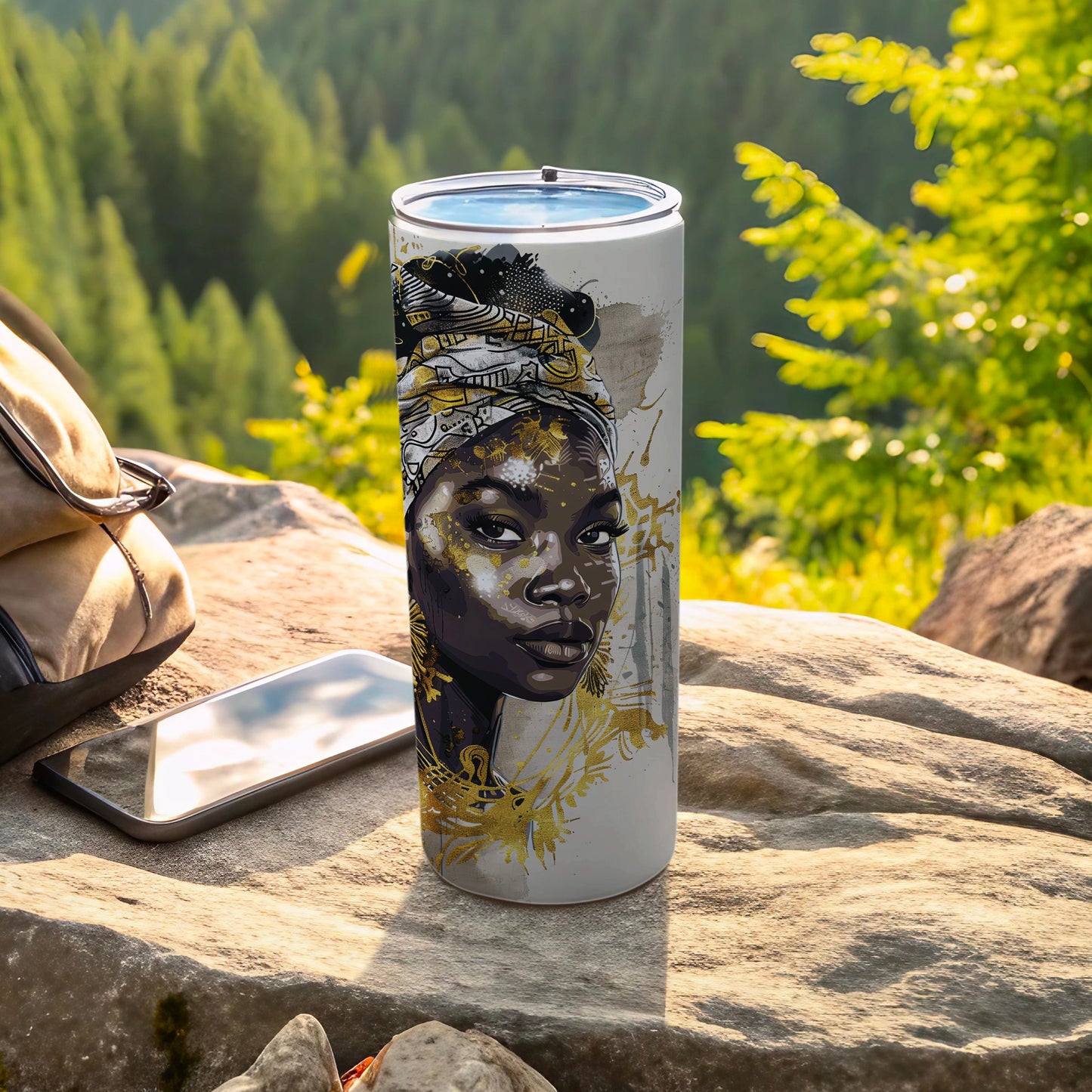 White tumbler with black and gold abstract art of a woman's face.