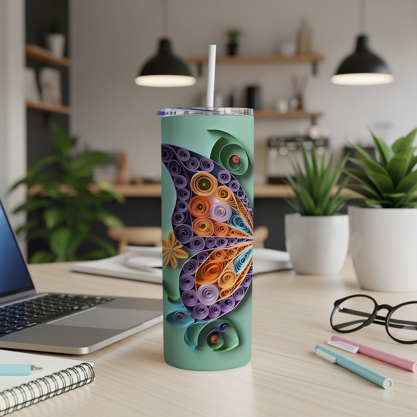 Green tumbler with a purple, orange, and blue quilled butterfly design.