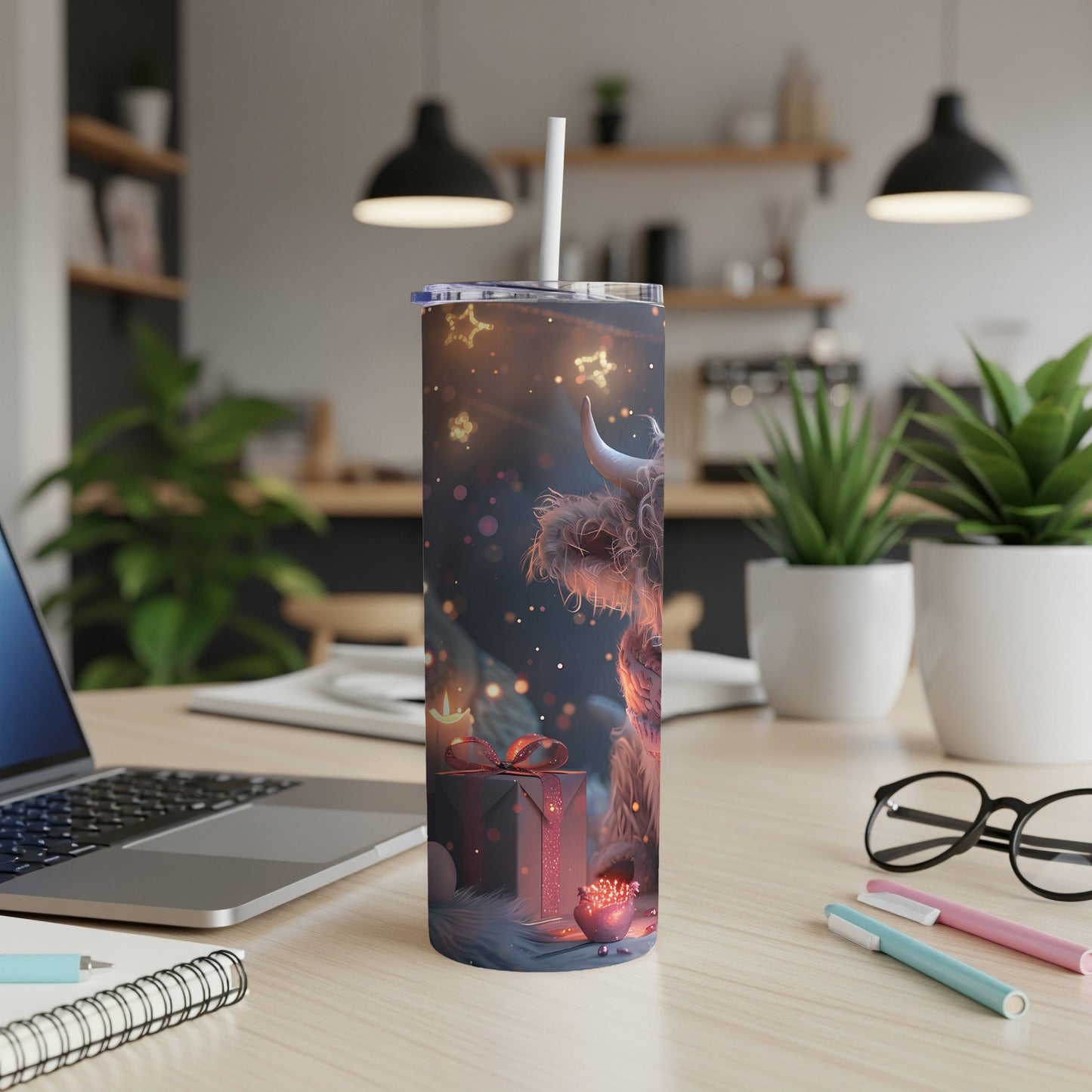 Highland cow with festive lights and gift on a tumbler.