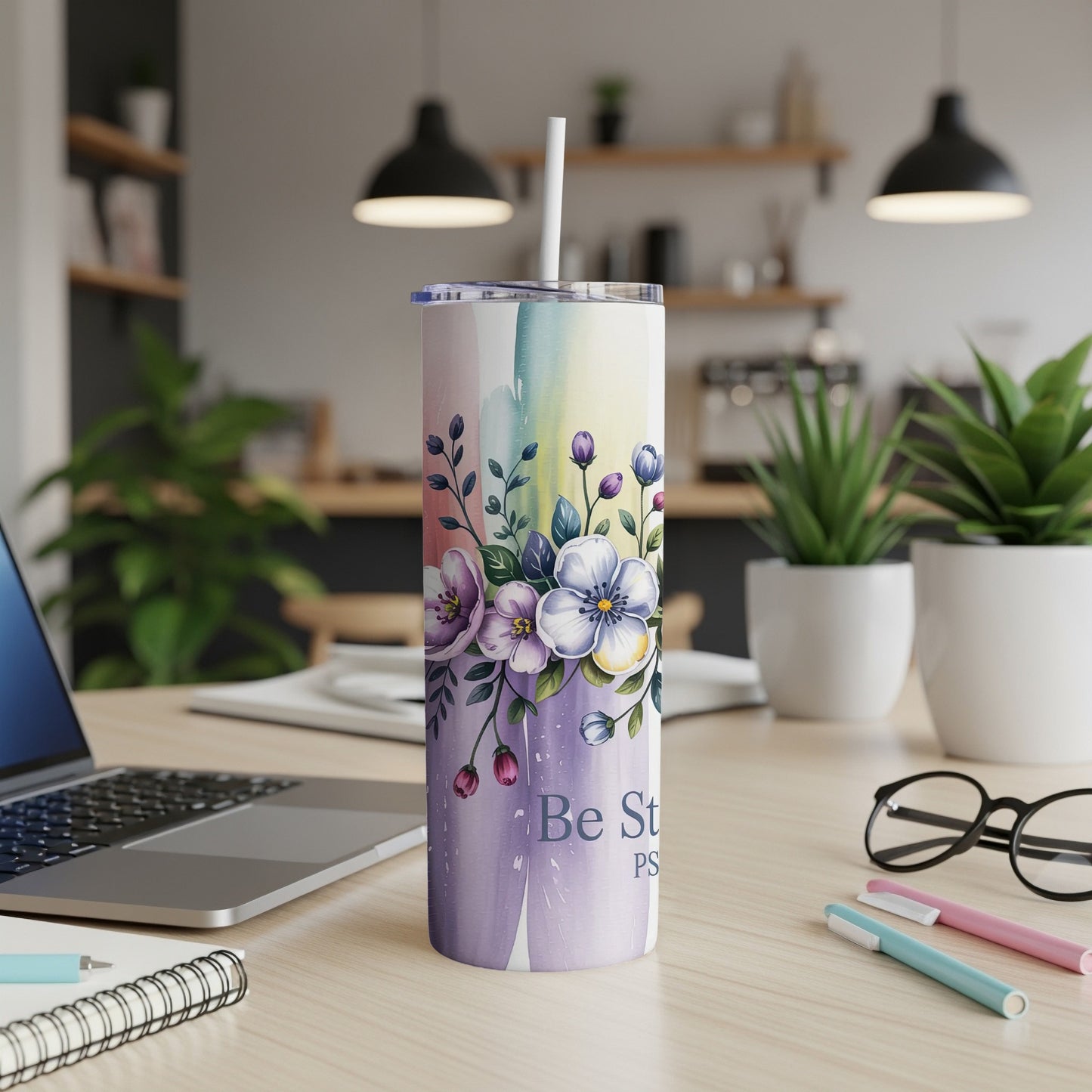 Rainbow watercolor tumbler with floral design and "Be Still" text.