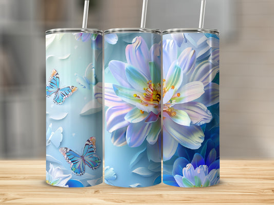 Three tumblers with blue butterflies and white flowers on a wooden surface.