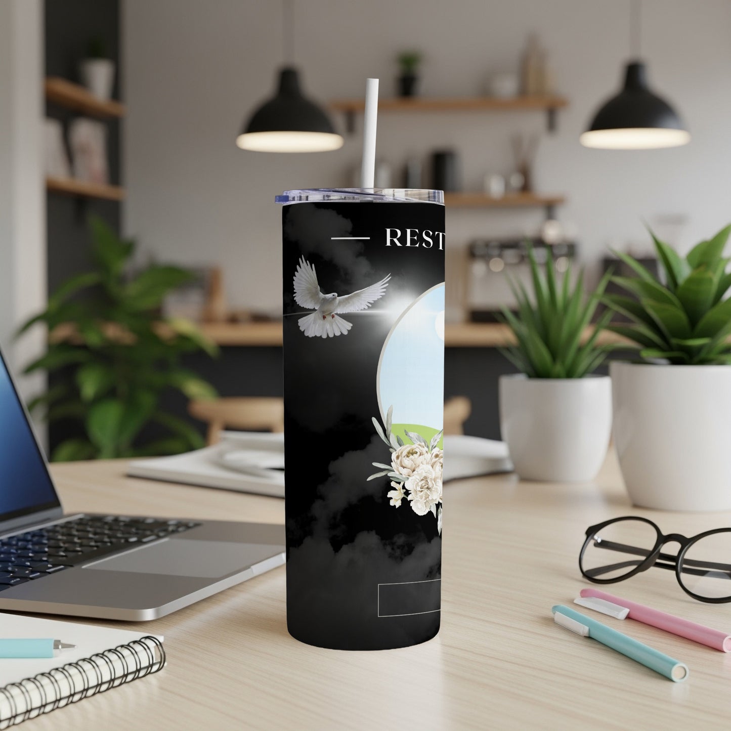Black tumbler with dove, flowers, and text "REST".