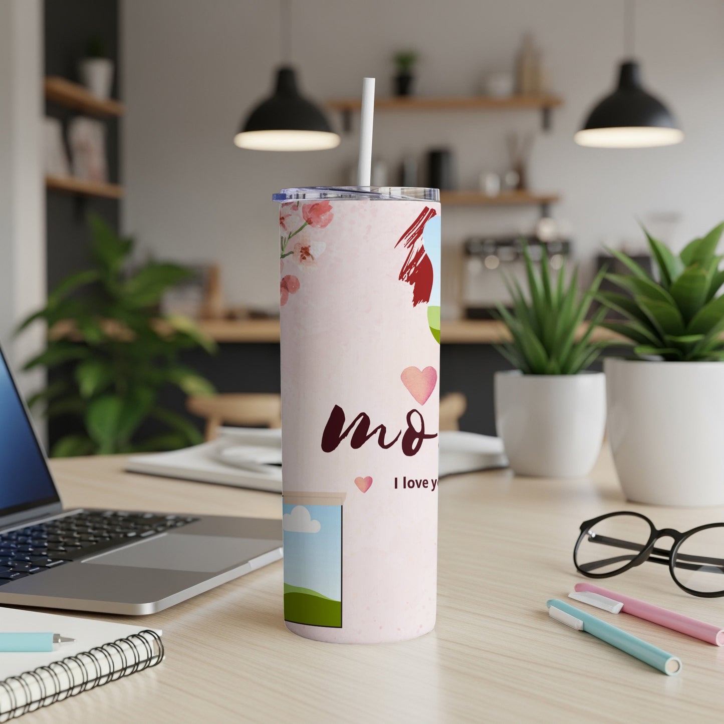 Light pink tumbler with floral and heart design, reading "mom I love y".
