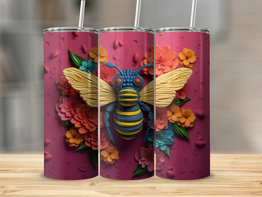 Three tumblers with a bee and floral design on a wooden surface.