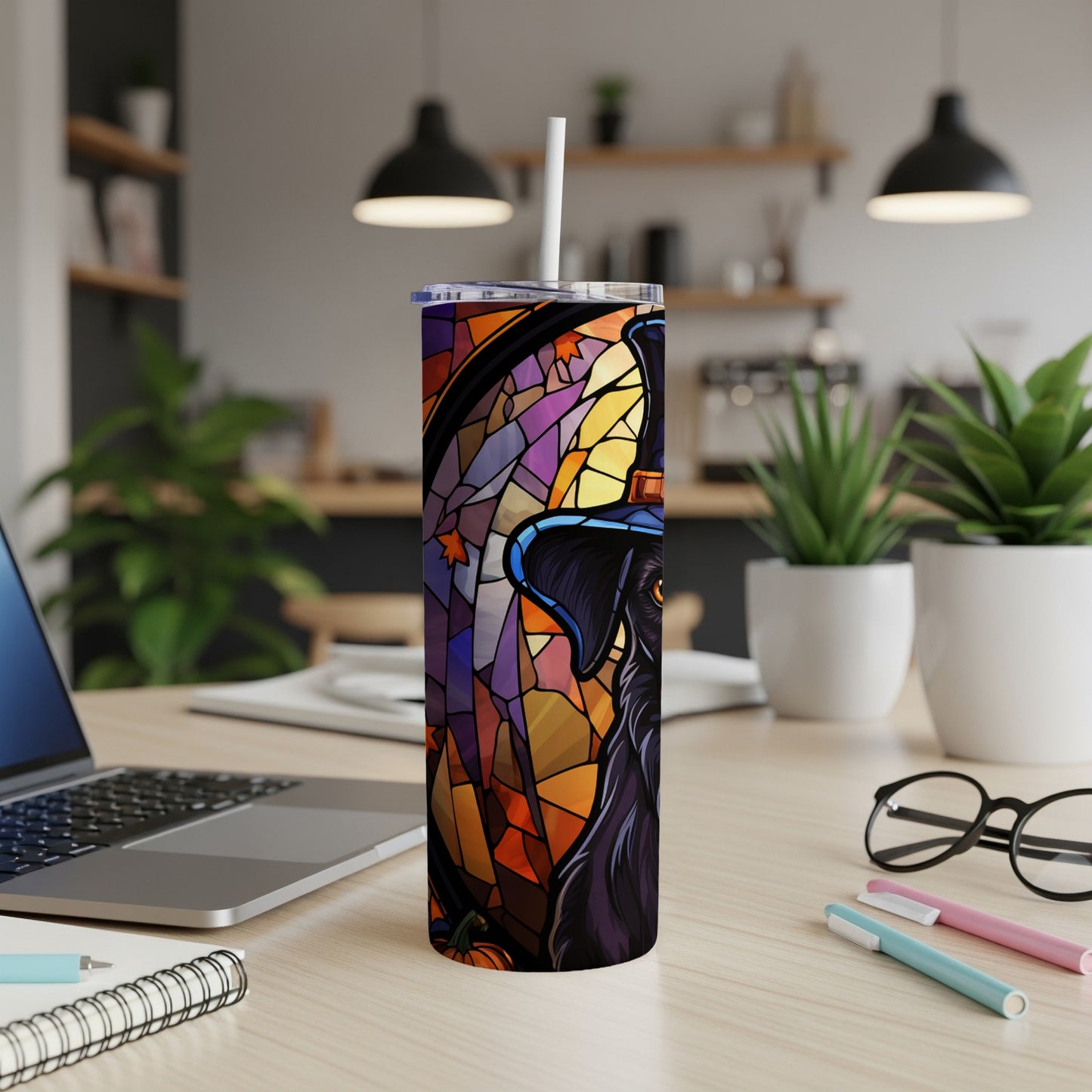 Black dog wearing a witch hat in a stained-glass style on a tumbler.