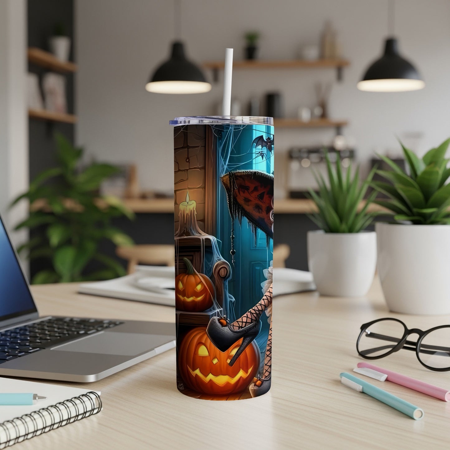 Tall tumbler with Halloween theme art featuring pumpkins, bats, and a witch's leg.