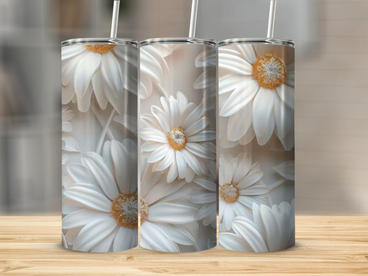 Three tumblers featuring white daisy floral pattern on a wooden surface.