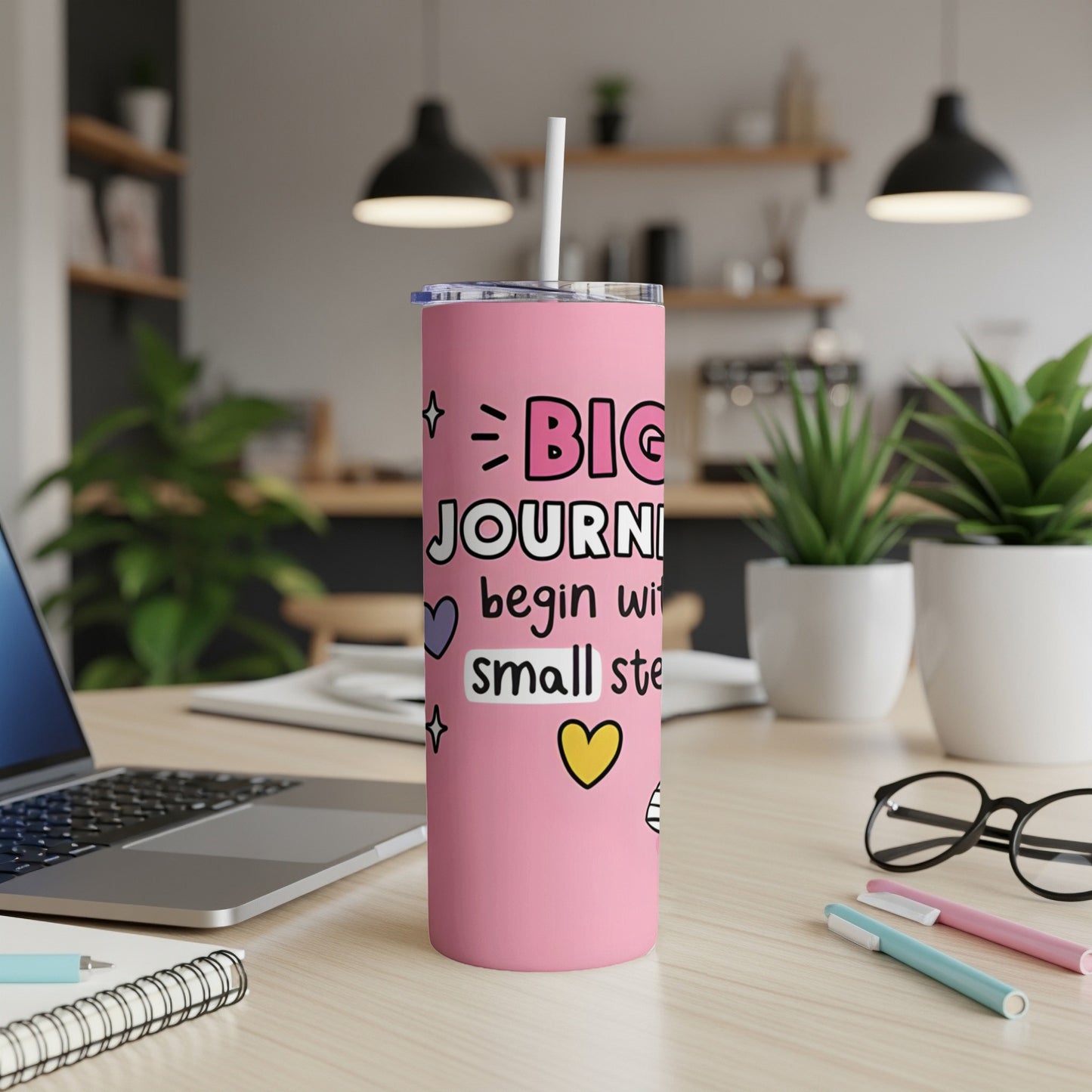 Pink tumbler with "BIG JOURNEYS begin with small steps" and heart graphics.