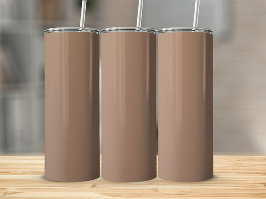 Three plain brown tumblers with white straws on a wooden surface.