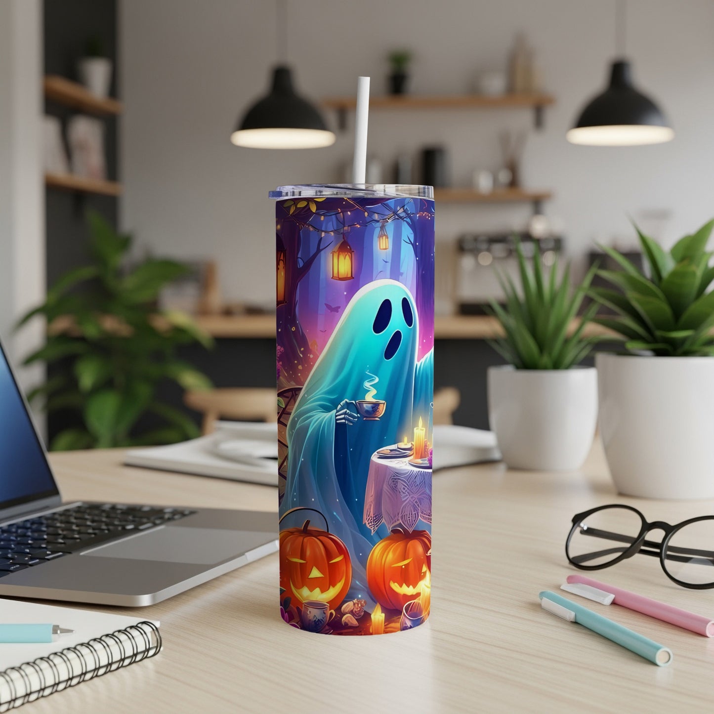 Halloween tumbler with a blue ghost drinking tea amongst pumpkins and lanterns.