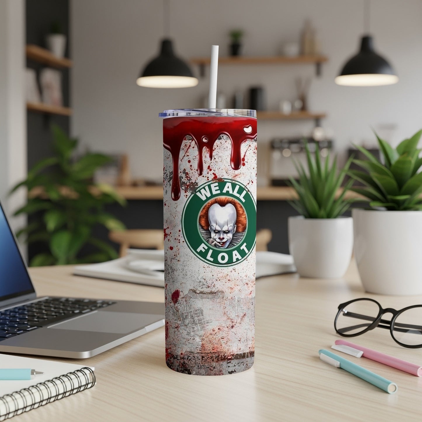 Tumbler with Pennywise graphic and "We All Float" text on a bloody background.