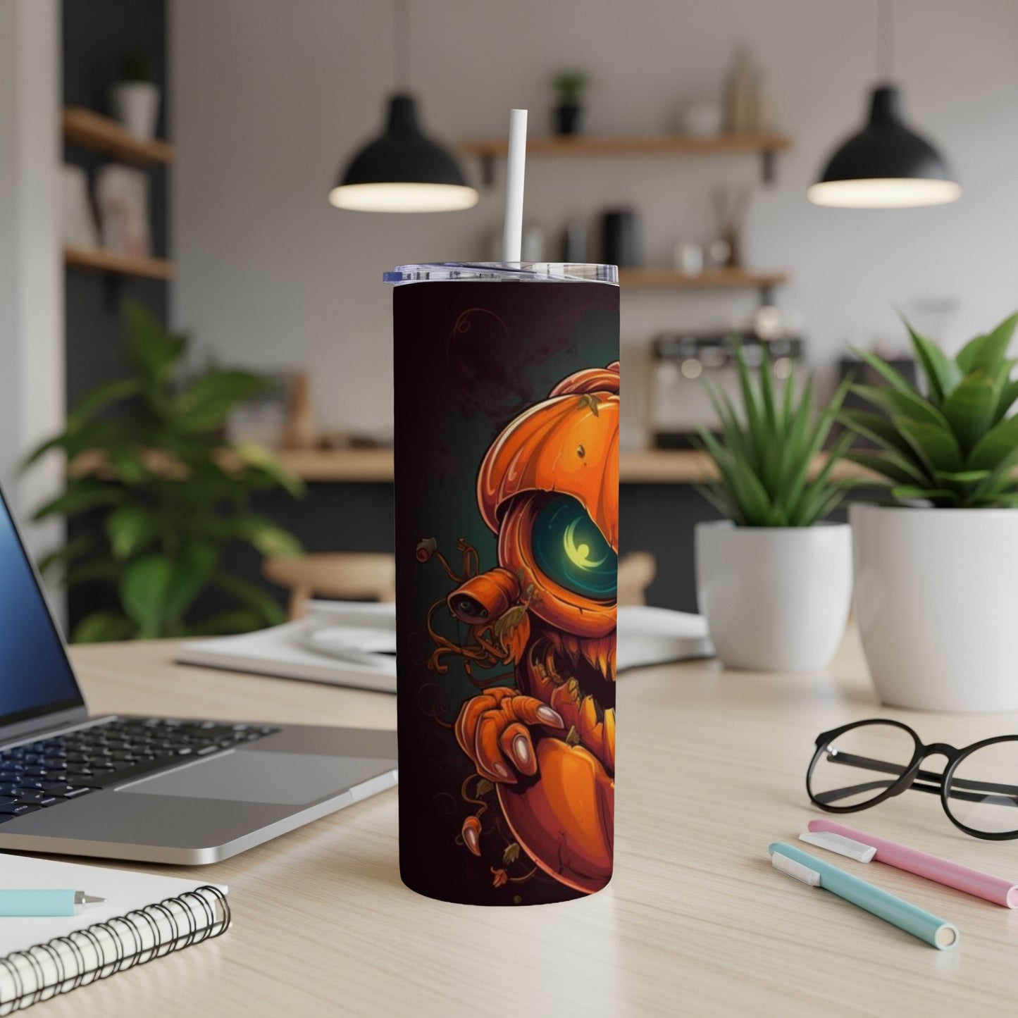 Tall tumbler with a spooky jack-o'-lantern illustration and a straw.