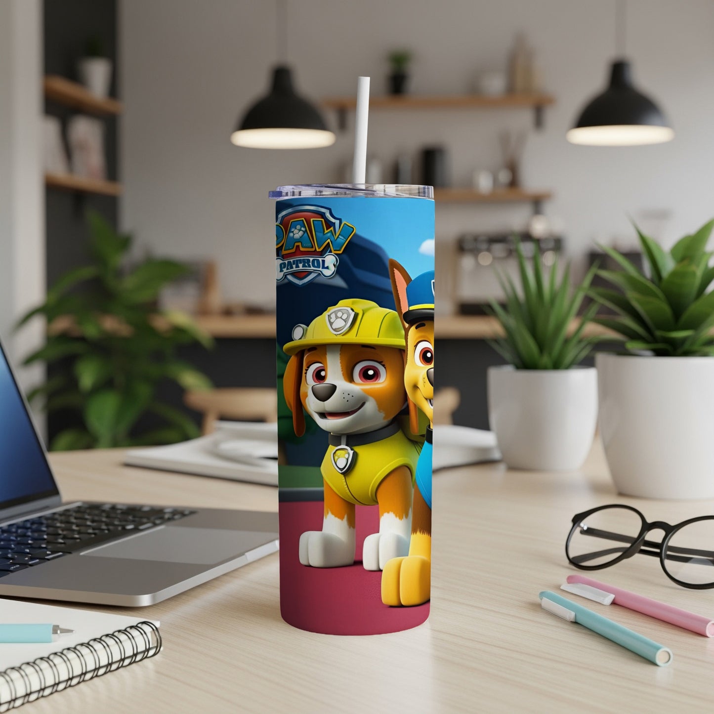 Chase and Marshall from Paw Patrol on a colorful tumbler with a laptop and desk supplies.