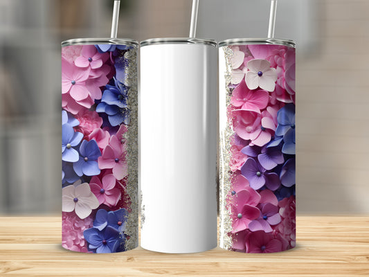 Three tumblers with floral patterns in pink and blue, one blank.