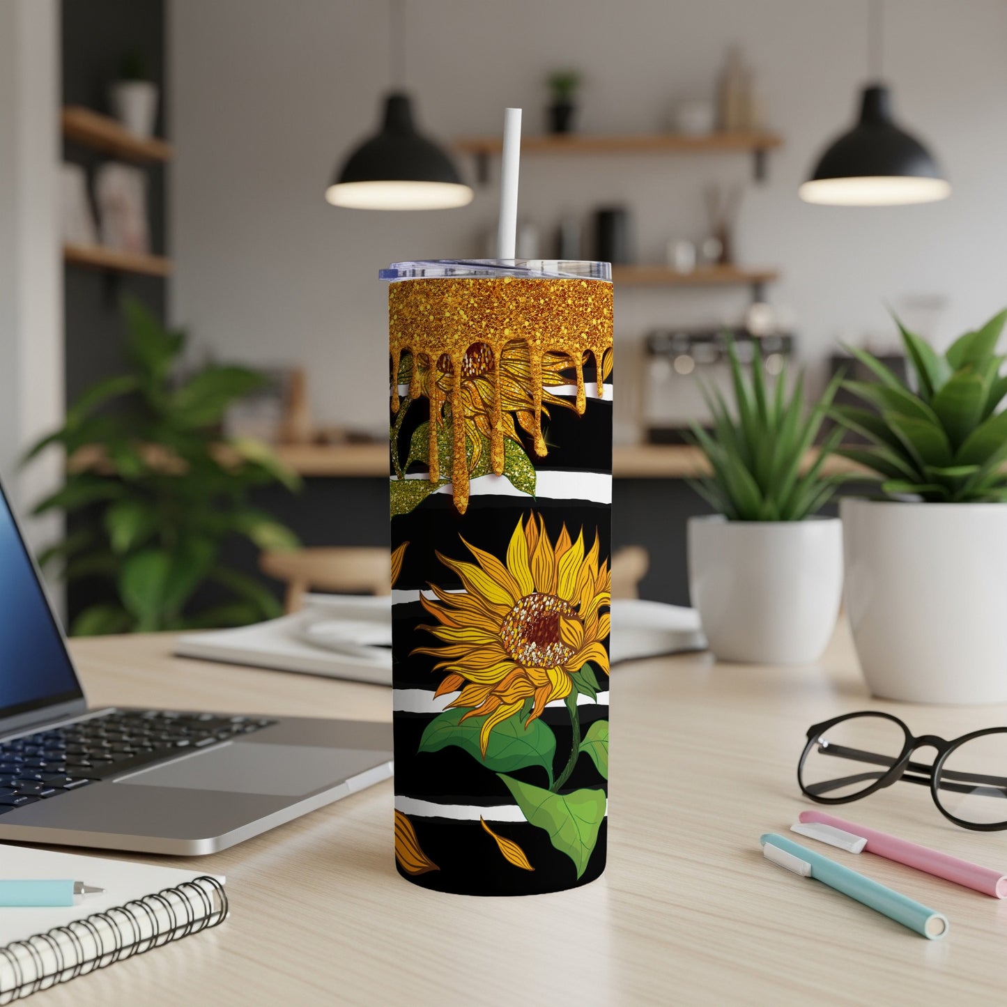Tall tumbler with sunflowers, gold glitter top, and black and white stripes.