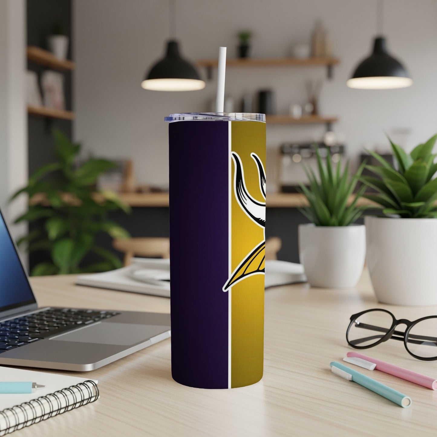 Minnesota Vikings tumbler with purple and gold design and white straw.