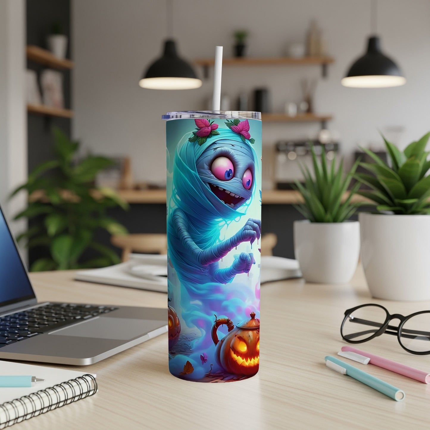 Tumbler with cartoon mummy, pink flowers, and glowing jack-o'-lanterns.
