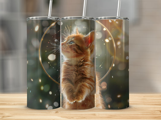 Three tumblers with orange kitten art and golden bokeh effects.