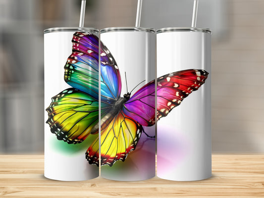 Three tumblers featuring a colorful butterfly design with rainbow wings.