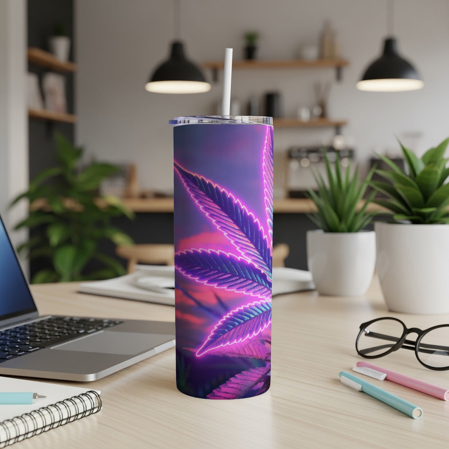 Neon purple cannabis leaf tumbler on a desk with a laptop and office supplies.