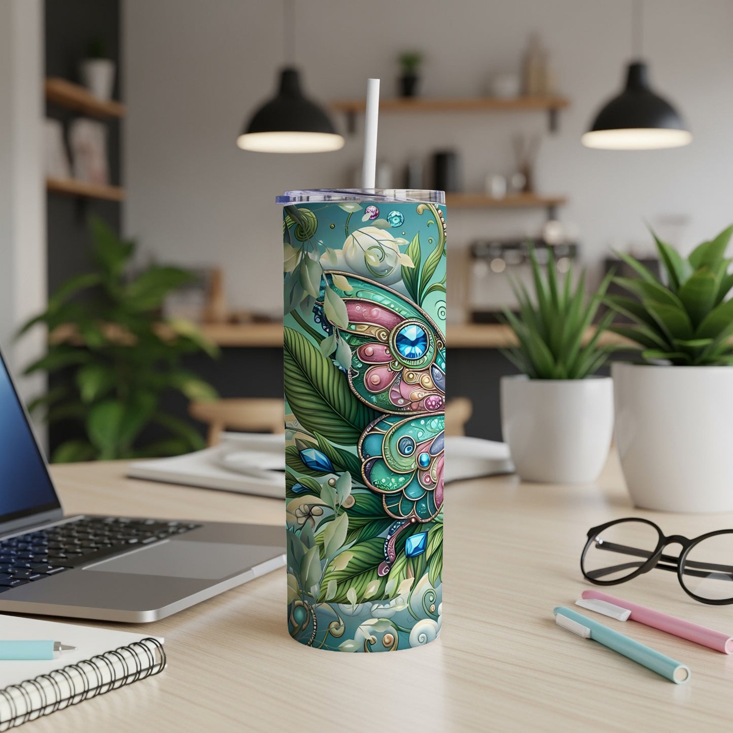 Tumbler with a butterfly and floral pattern, straw inserted.