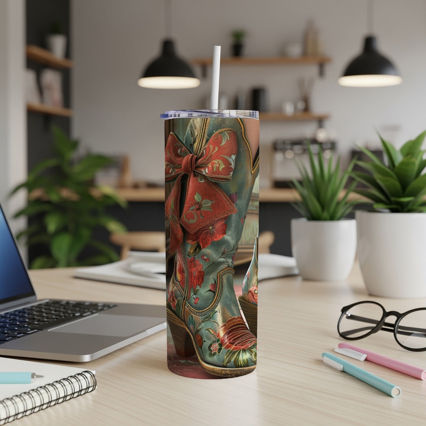 Cowboy boots with red ribbon and floral pattern on a tumbler.