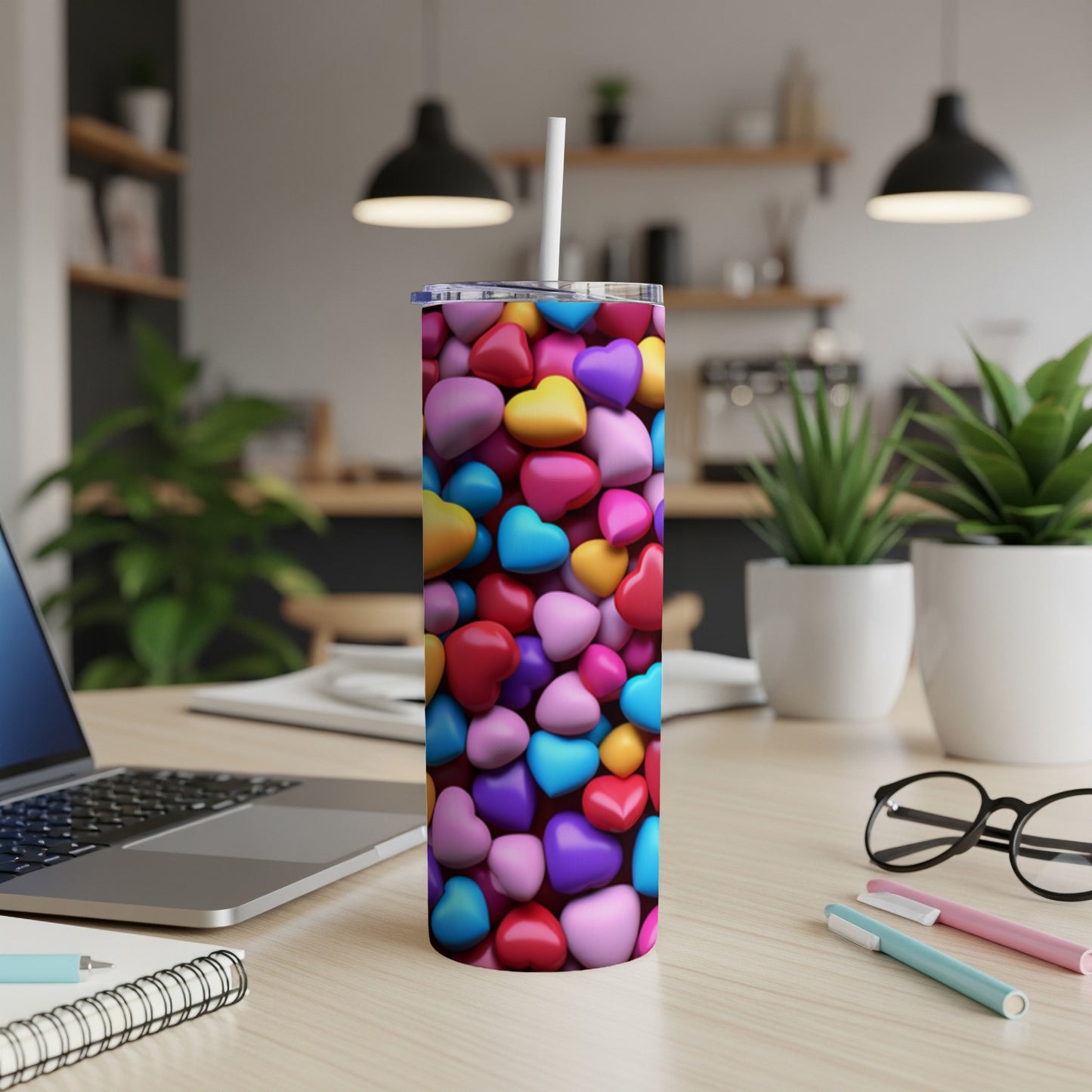 Tumbler covered in colorful heart shapes with a white straw.