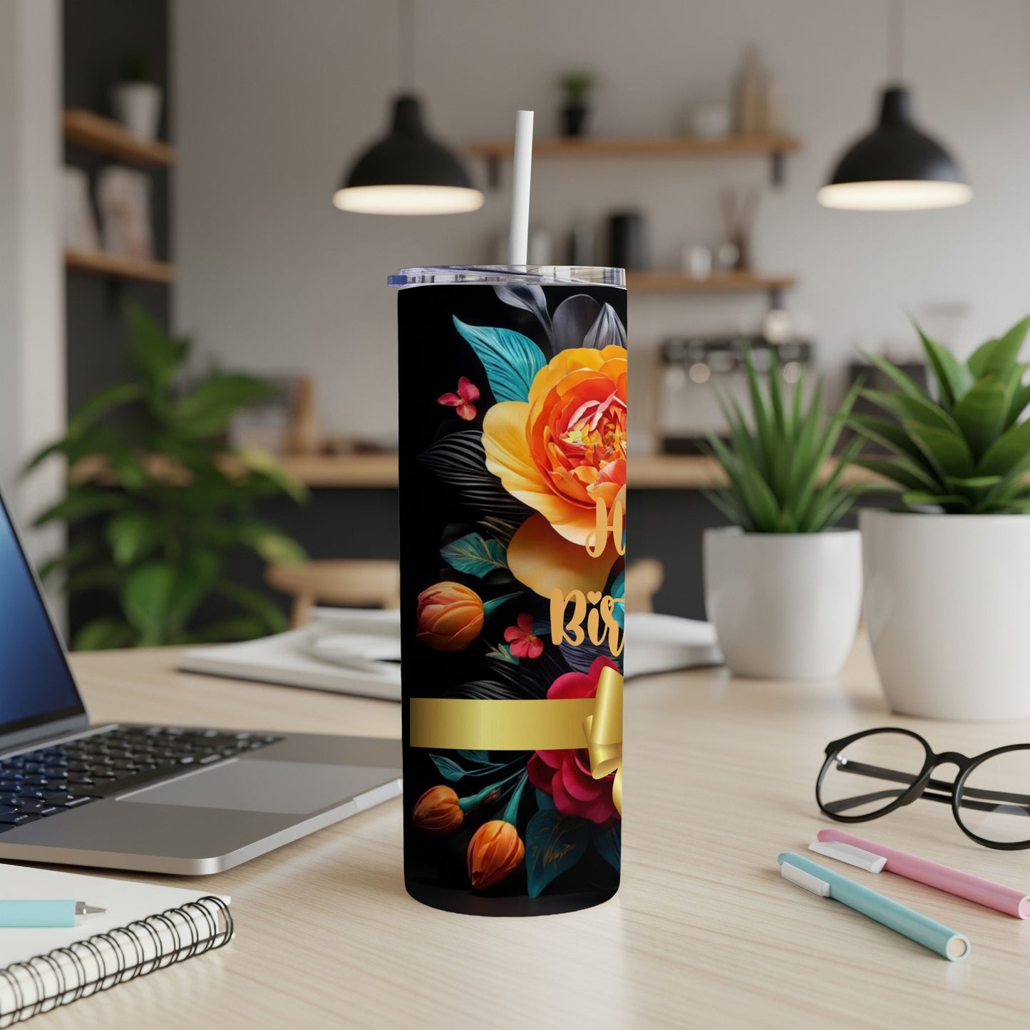 Black tumbler with colorful floral design and gold ribbon, "Happy Birthday" text.