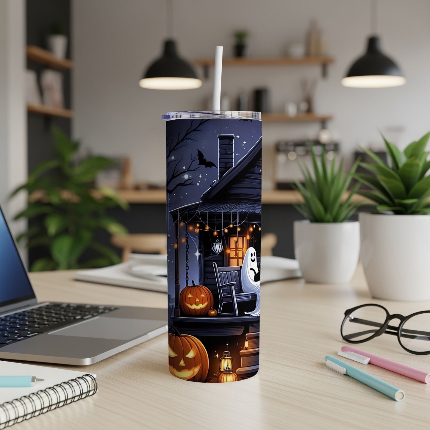 Tall tumbler with Halloween haunted house, pumpkins, and ghost design.
